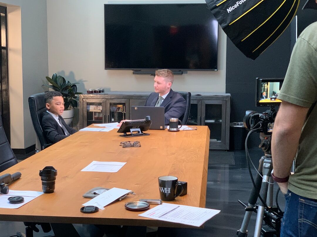 Two chairs facing each other in a lit interview studio