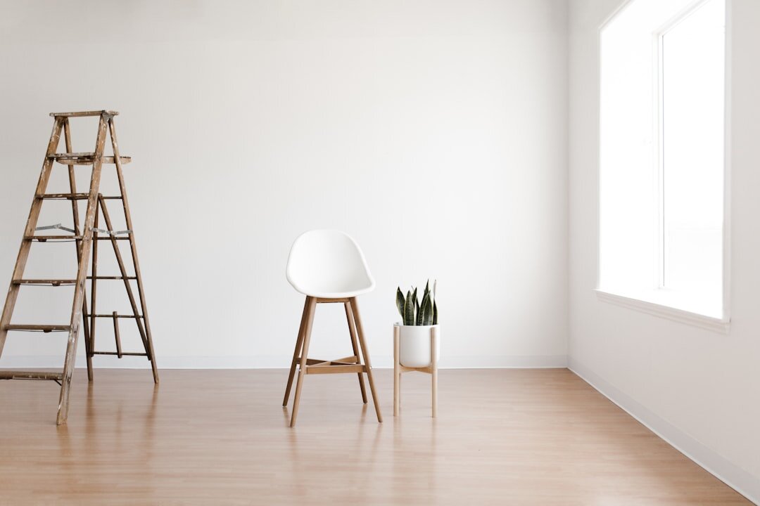 Camera tripod standing in an empty bright room