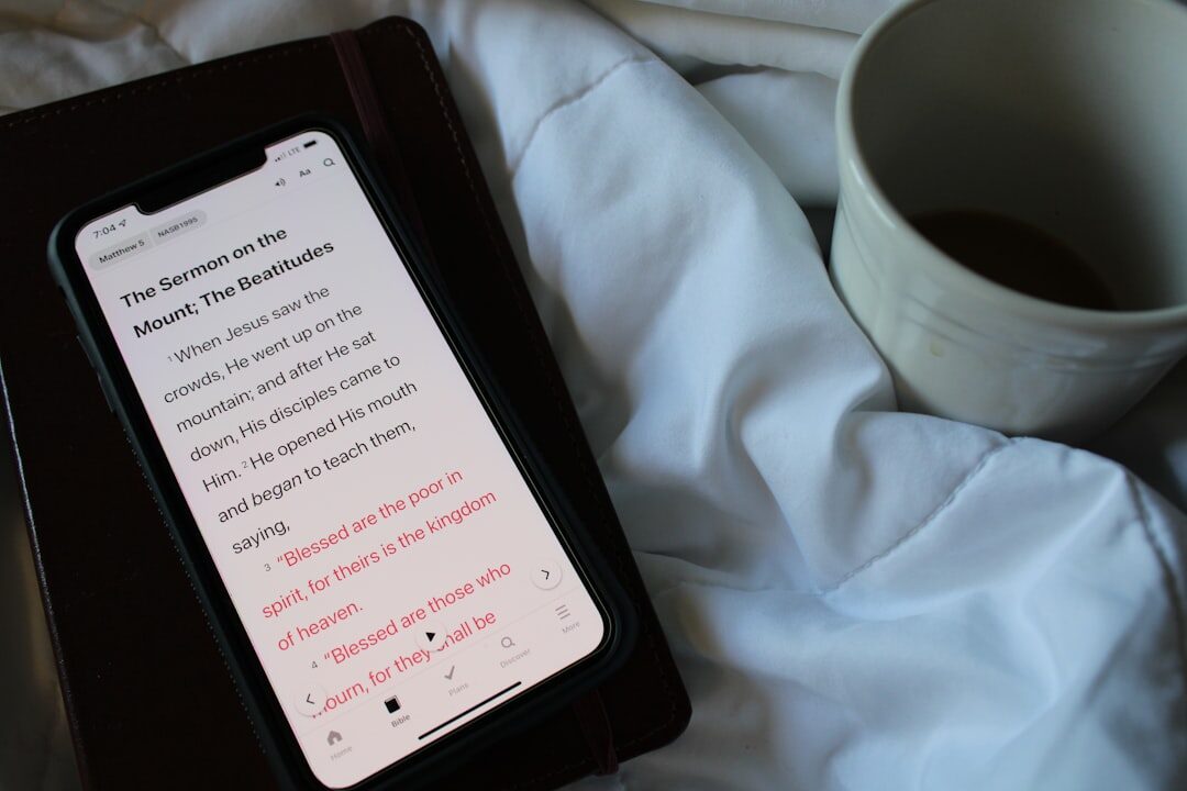 Open notebook with a shot list next to a smartphone and coffee cup