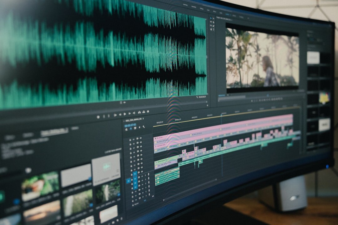 Laptop screen showing video editing timeline with color clips