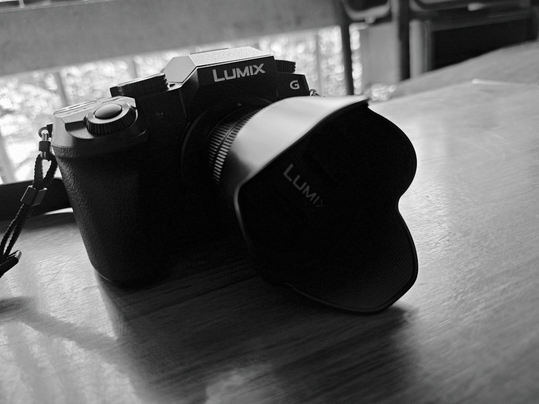 Mirrorless camera with lens resting on a wooden table